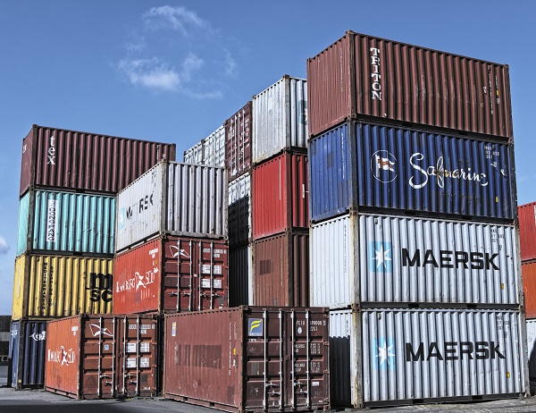 A group of containers kept in a harbor.
